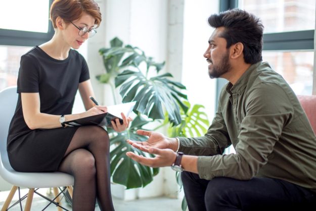 Finding Quality Outpatient Addiction Treatment in Jacksonville male talking to female therapist