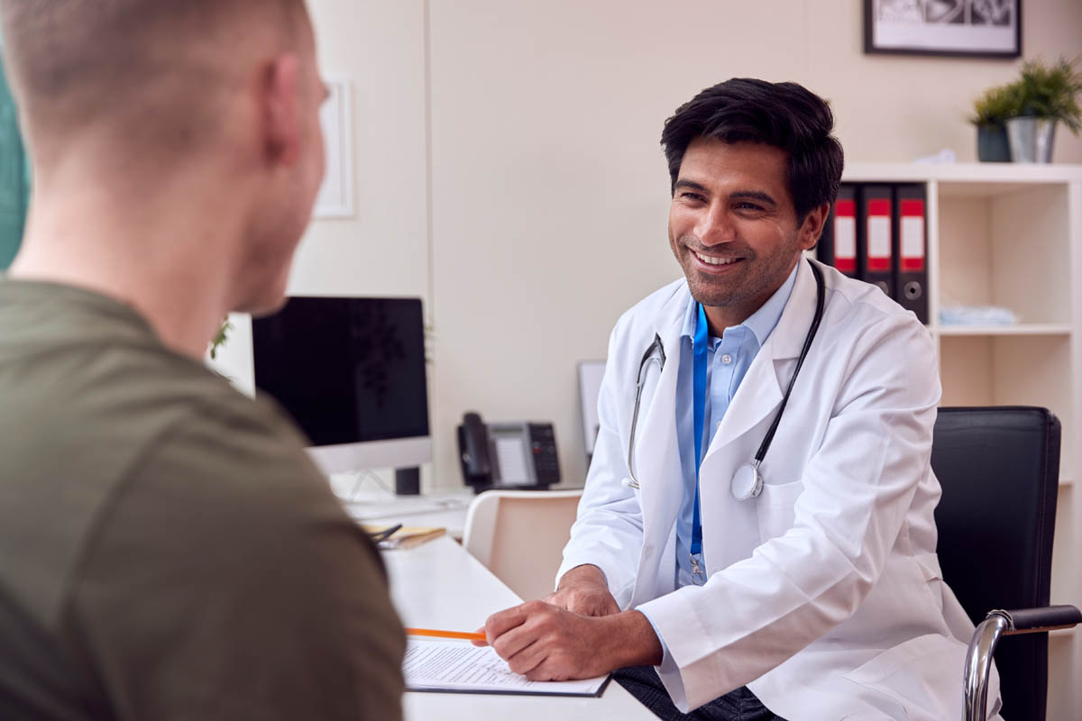 Benefits Of MAT For Addiction Recovery smiling clinician telling client about the benefits of MAT for addiction recovery