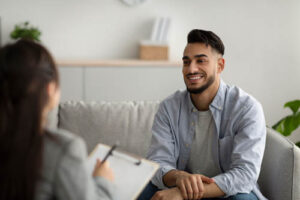 Person smiling during counseling session in individual therapy 