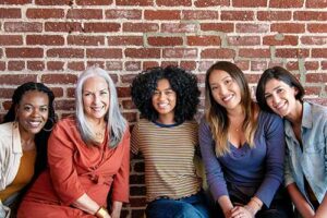 a group of women in a women's rehab program smile
