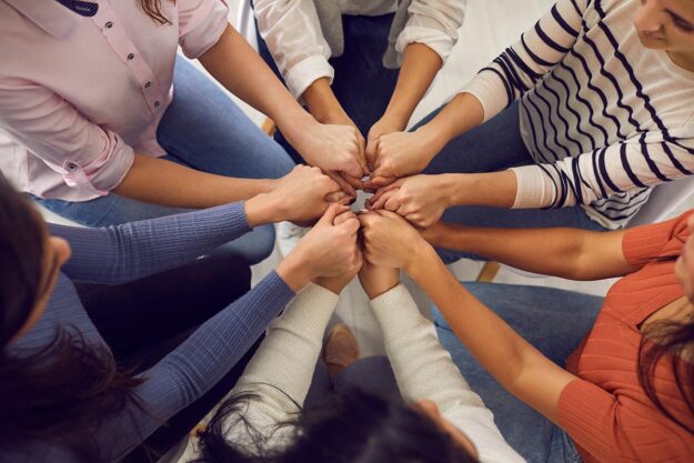 When to Consider an EIOP people in EIOP putting fists together in huddle in show of support during recovery