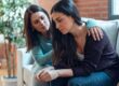 person comforting friend while sitting on couch after noticing signs of polysubstance abuse in a friend