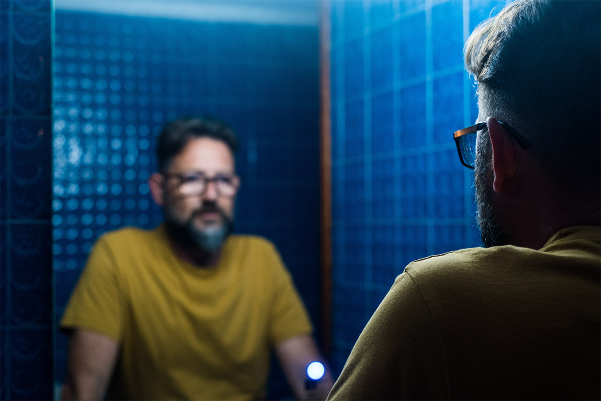 person looking in mirror wondering what to expect when you quit drinking