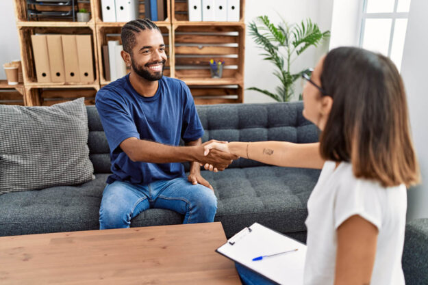What Are the Levels of Care in Addiction Treatment person shaking hands with clinician after learning about levels of care in addiction treatment