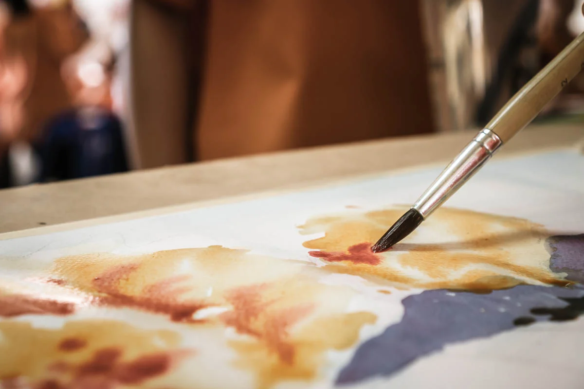 Person painting while enjoying the benefits of art therapy in recovery