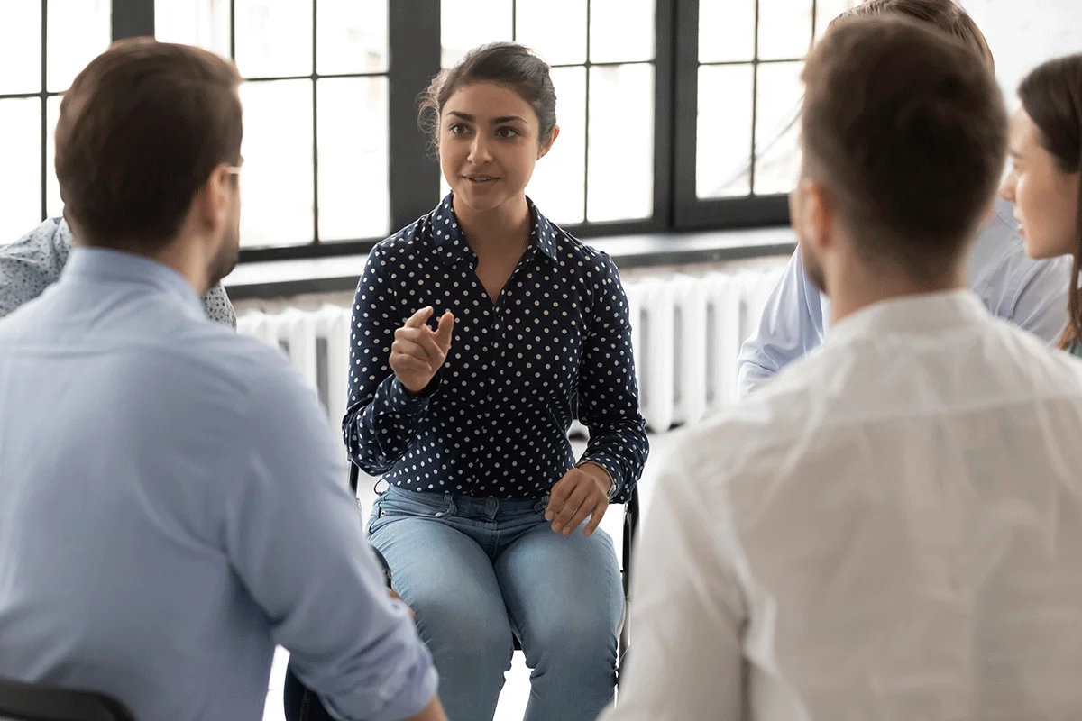 People in session with counselor experiencing the benefits of group therapy