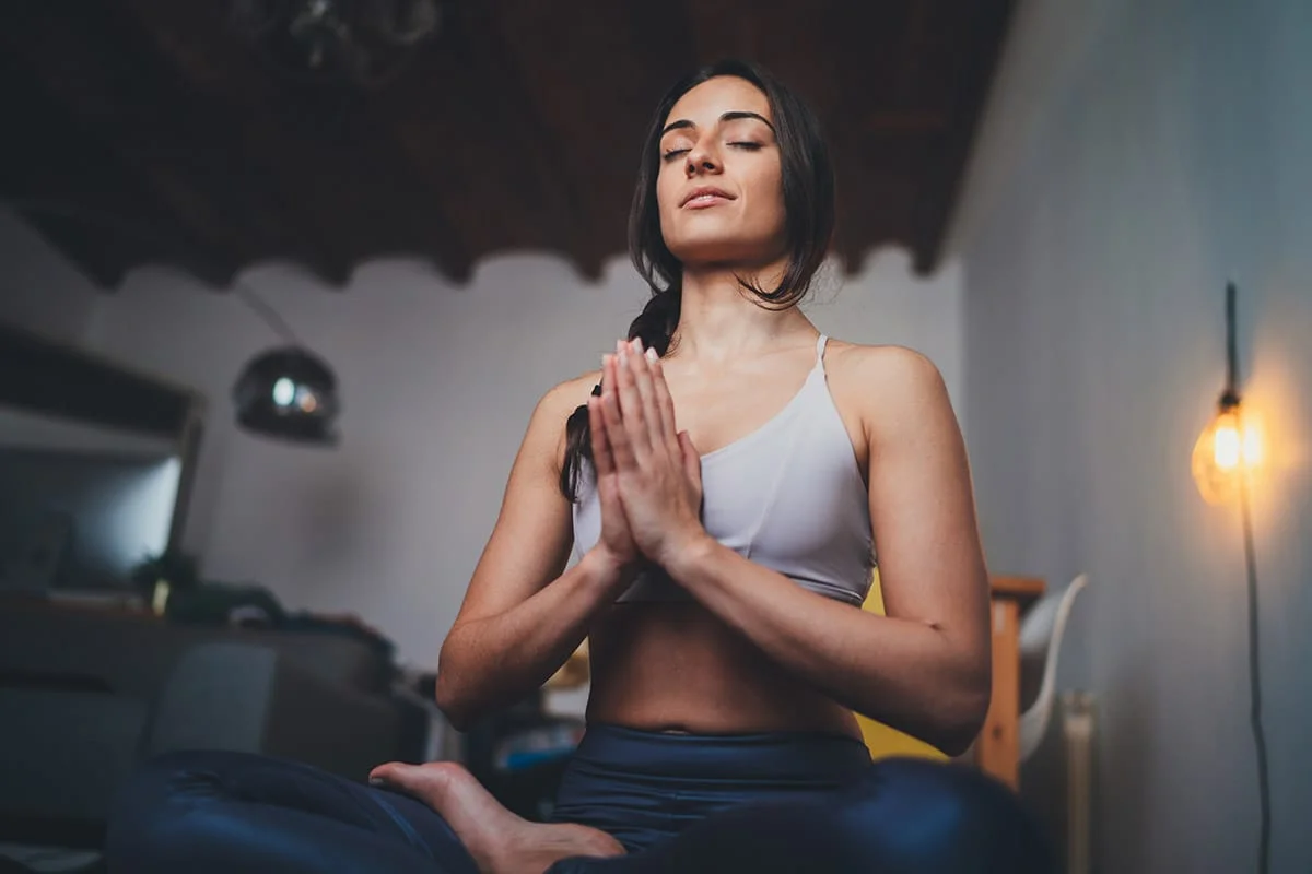 woman undergoing holistic treatment meditating in lotus position