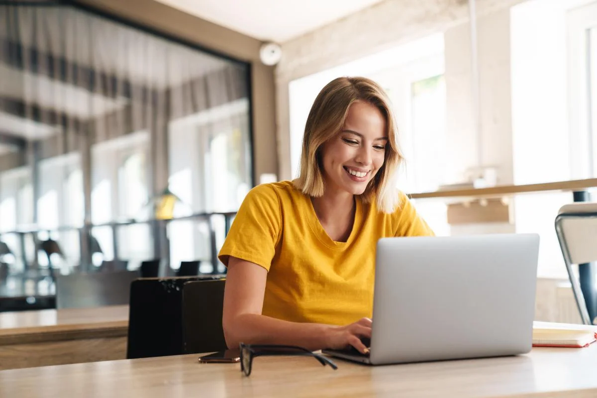a person sits in a library possibly researching the top Recovery bloggers