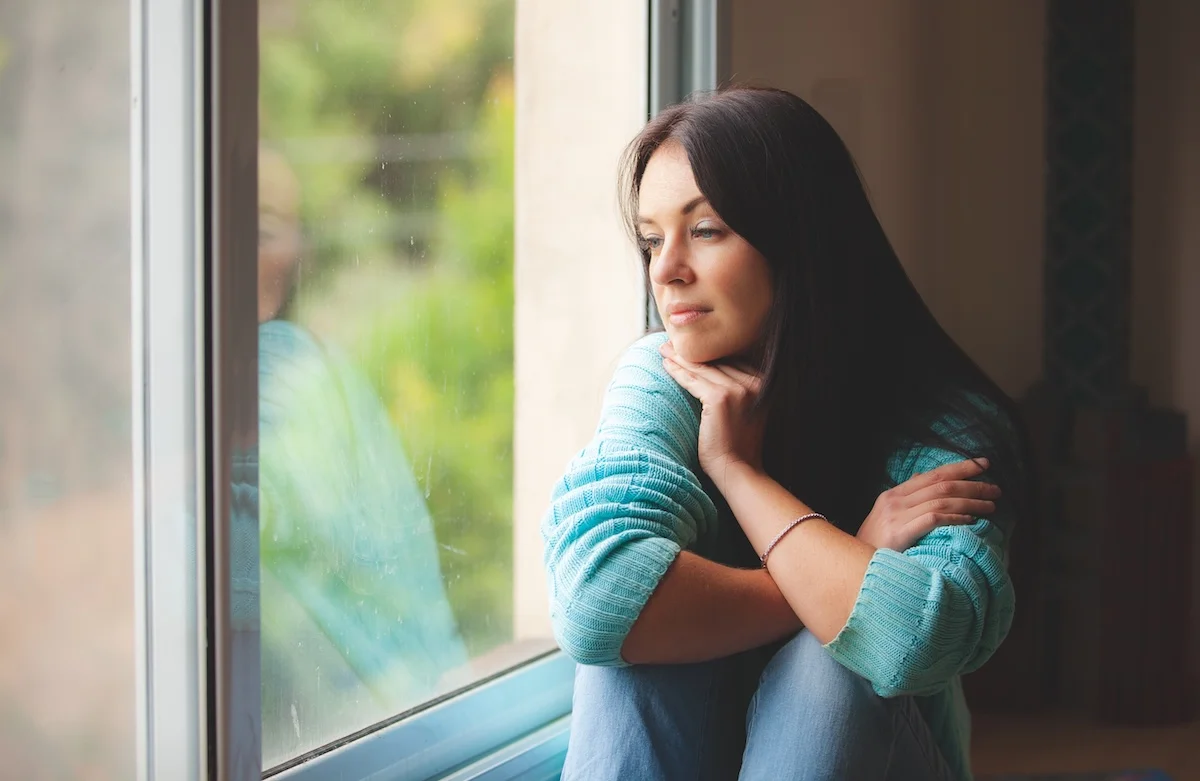 Woman sitting quietly by a window